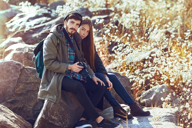 Young couple hipster outfit fashion style in love woman and man sea on background