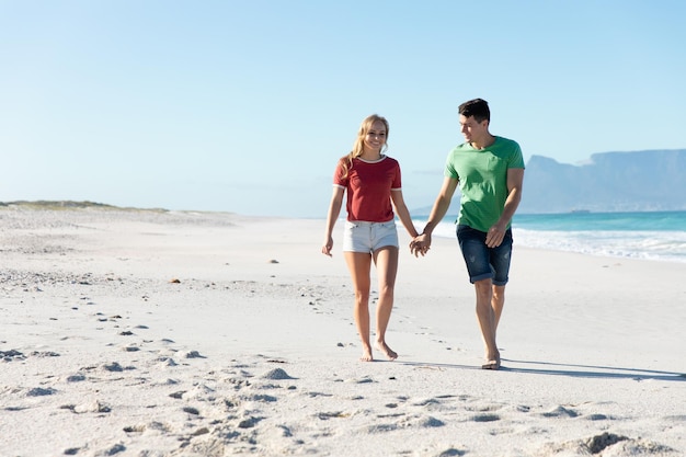 Young couple holding hands at the beach