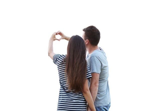 Young couple holding hands in shape of heart