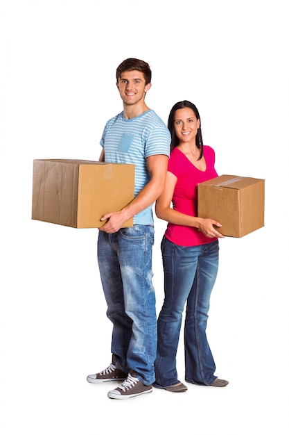 Young couple holding moving boxes