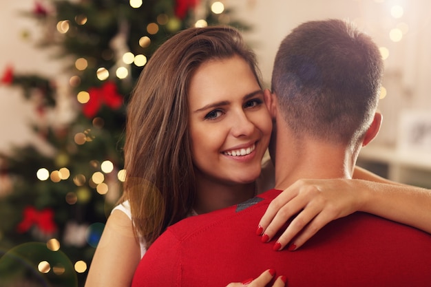 young couple hugging in Christmas time