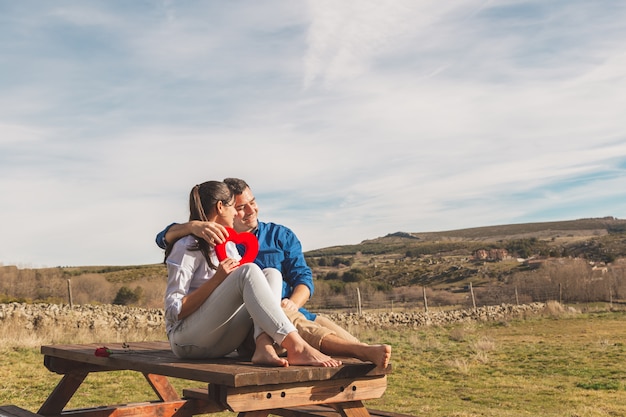 Young couple hugging and enjoying spending time together in the countryside