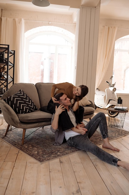 Young couple hugging and kissing at home in loft style interior Romantic couple of lovers