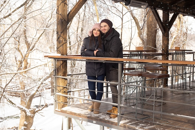 Young couple hugging in the Park in winter cafe