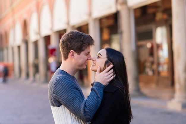 Young couple hugging on street