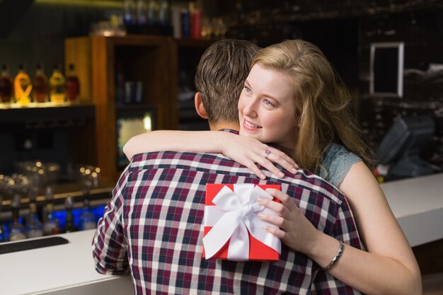 Young couple hugging with a gift