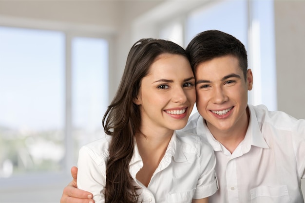 young couple hugs and smiles outdoor