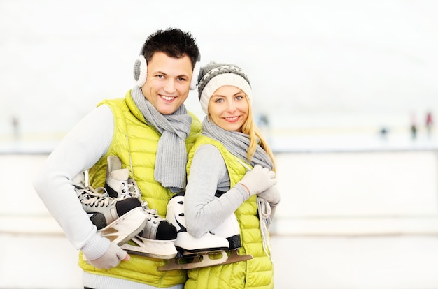 a young couple ice-skating on a rink