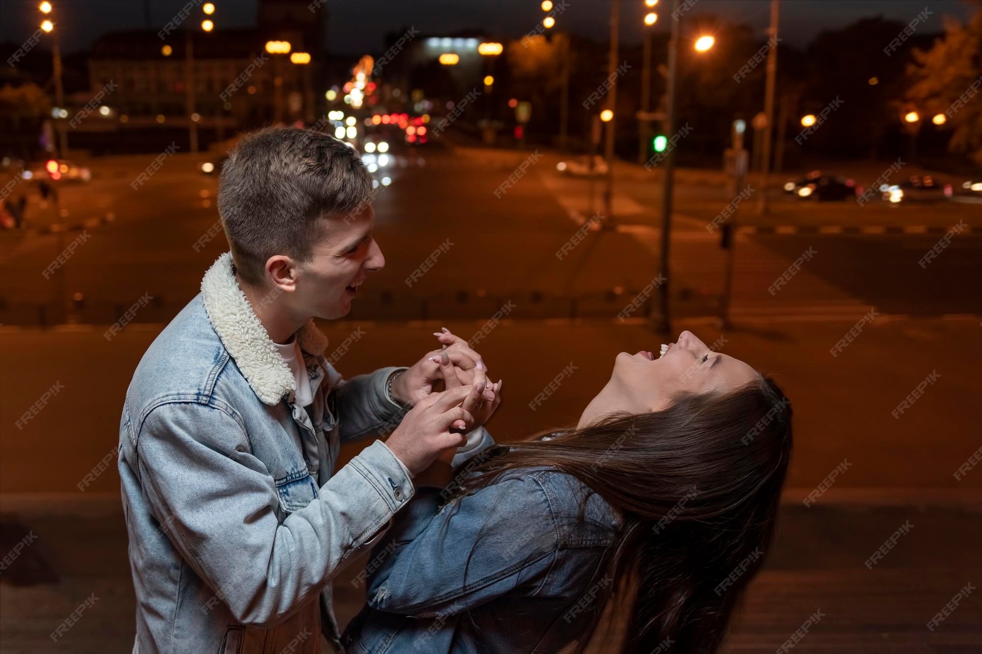 Premium Photo | Young couple is having fun and laughing on evening city background romantic date