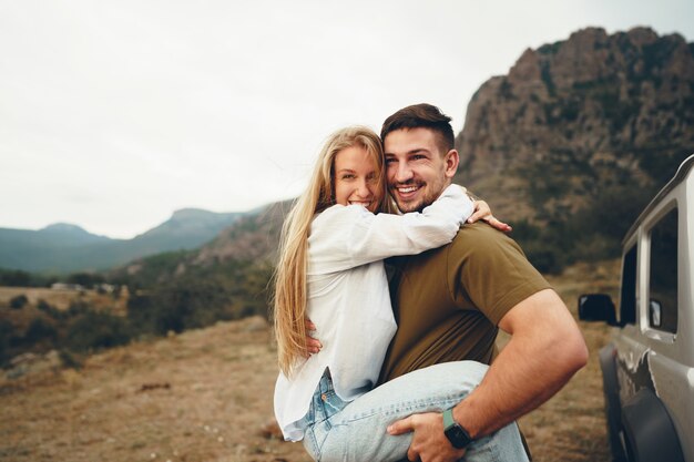 Young couple is on romantic trip to the mountains by car