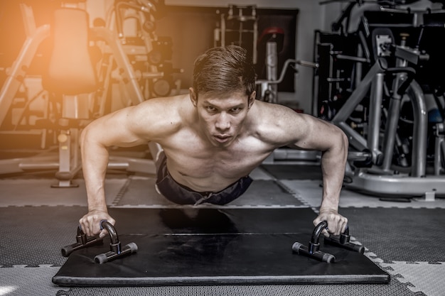 Young couple is working out at gym