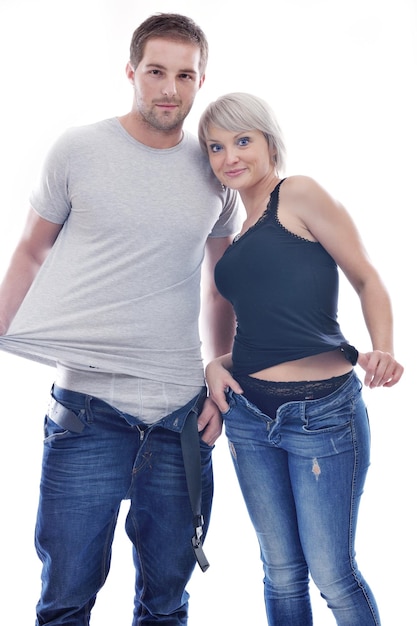 Photo young couple isolated on white in fashionable underwear and blue jeans clothing