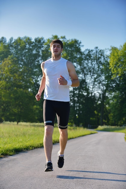 Young couple jogging in park at morning. Health and fitness concept