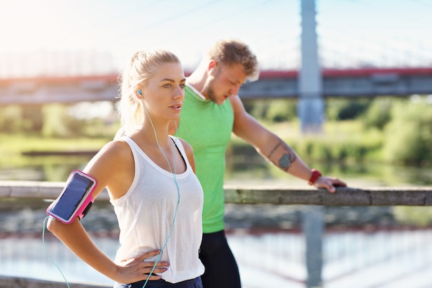 young couple jogging in park in summer