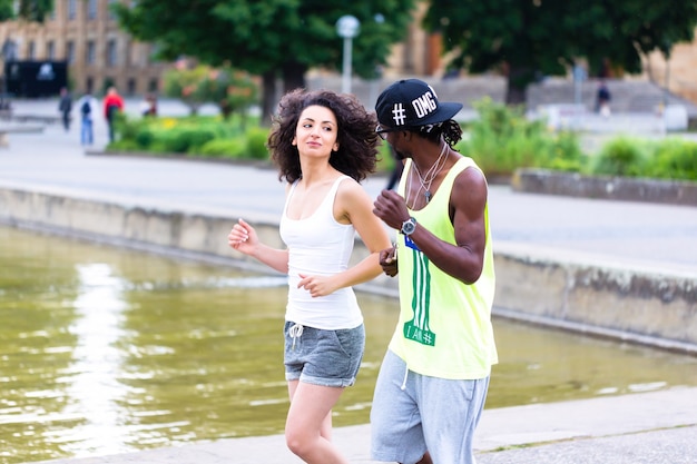 Young couple jogging through city center