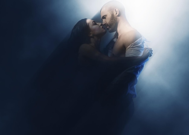 young couple kissing against wall