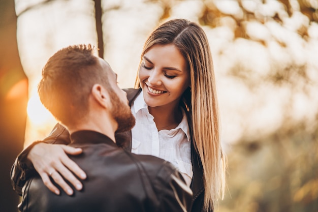 Young couple kissing in autumnal park