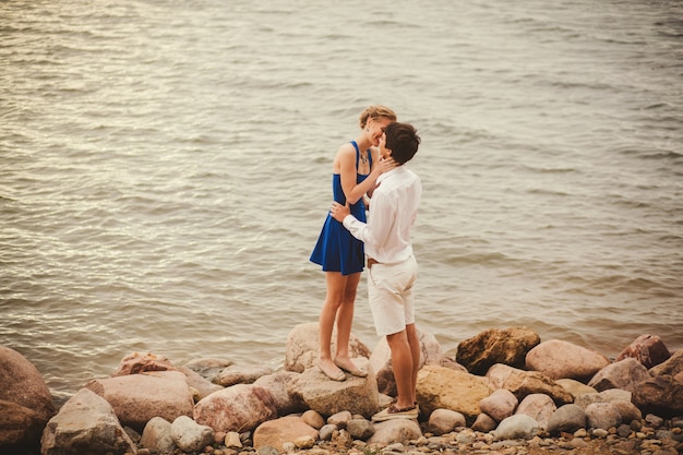 A young couple kissing on the beach