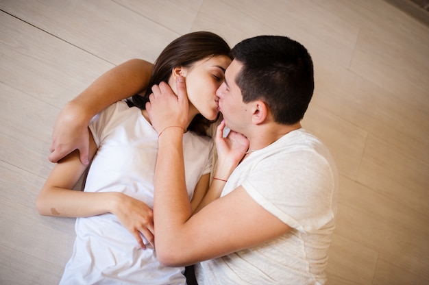 Young couple kissing on the floor