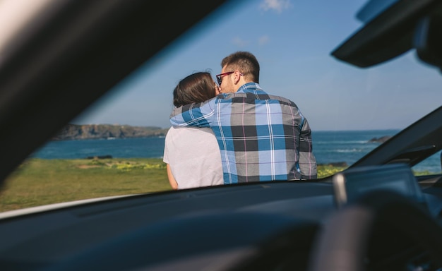 Young couple kissing near the coast