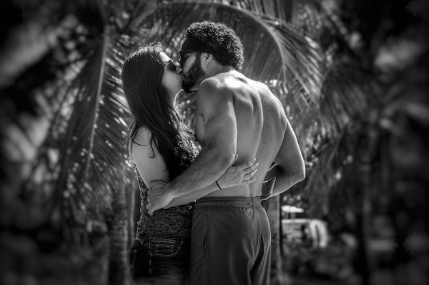 young couple kissing in park