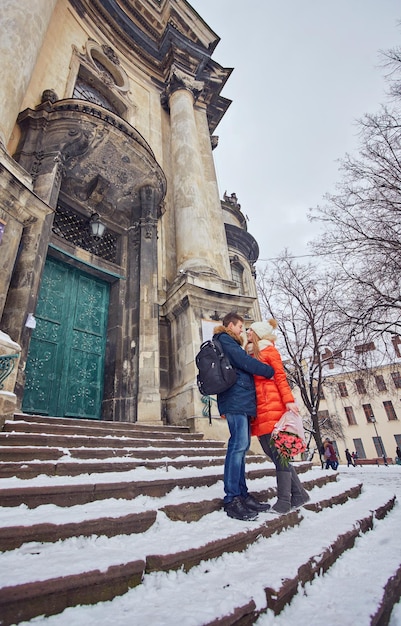 Young couple kissing at wintertime outdoors