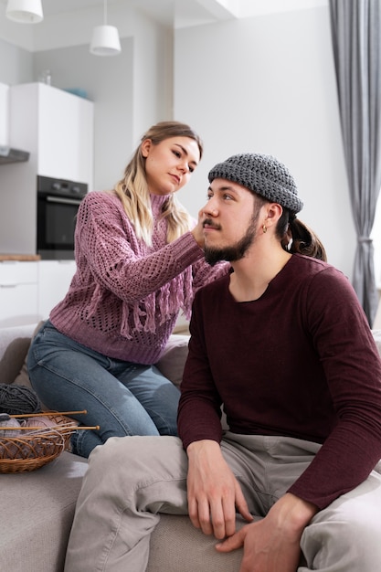 Young couple knitting together