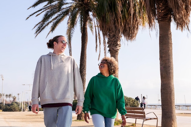 Young couple laughing funny while taking a walk