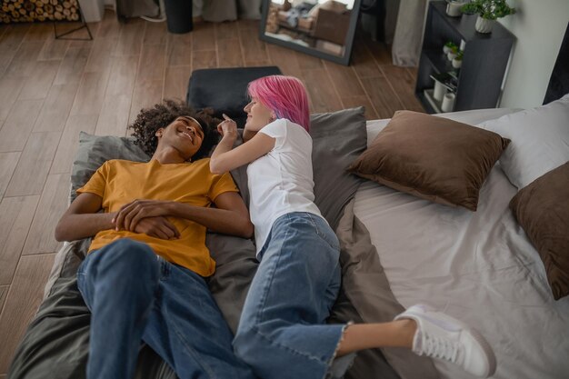 Young couple laying in bed and looking relaxed