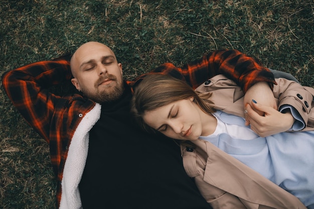 Young couple laying on grass summer love