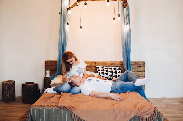 Young couple laying together in bed