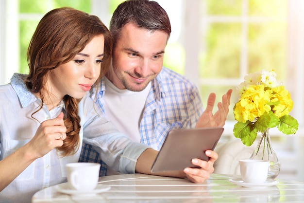 Young couple looking at digital tablet