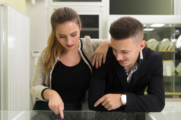 Young Couple Looking at Jewels in Jewelry Shop