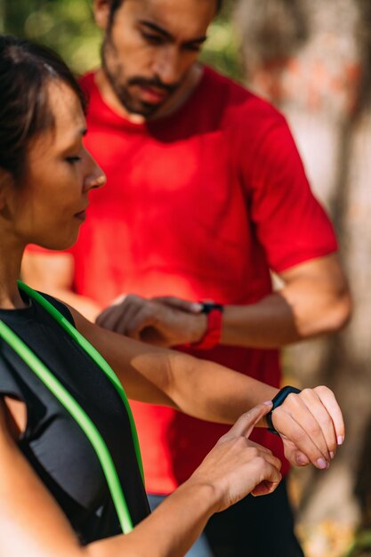 Young couple Looking at Their Smart Watches