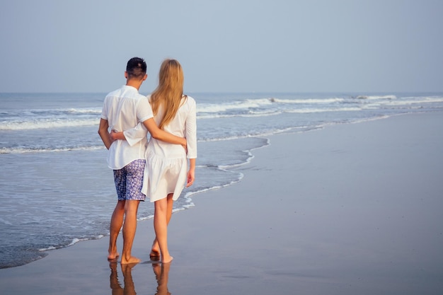 Young couple in love on the beach February 14 St Valentines Day sunset Goa India vacation trip travel new year in a tropical country freedom concept