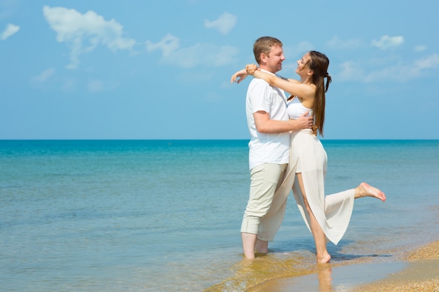 A young couple in love on the beach