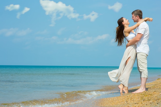 A young couple in love on the beach