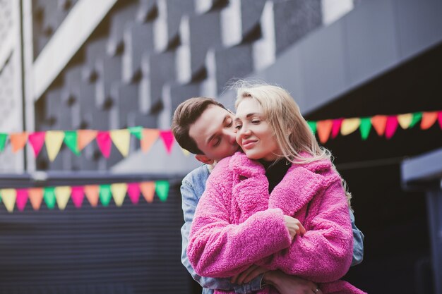 Young couple in love embraces in the city. Valentine's day