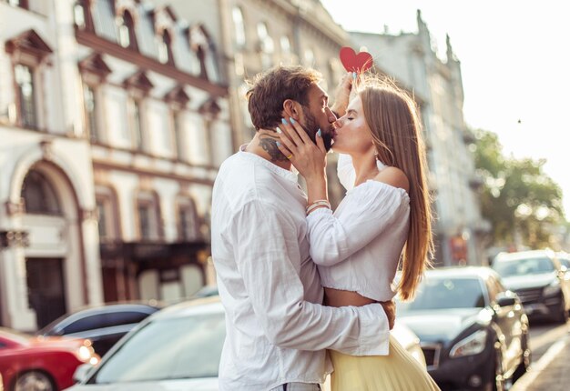 Young couple in love hold a red heart show their love and kiss in the city Romantic concept