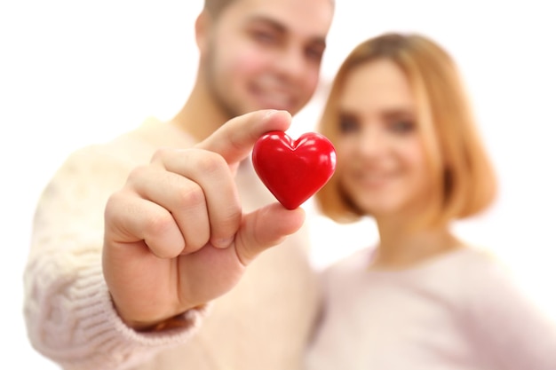 Young couple in love holding red heart close up