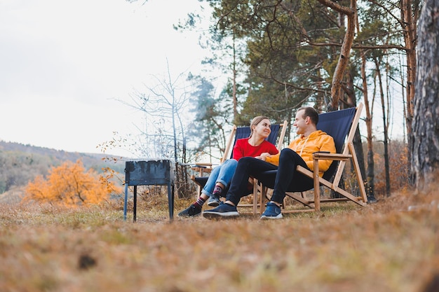 A young couple in love is grilling a barbecue in nature Family recreation in nature