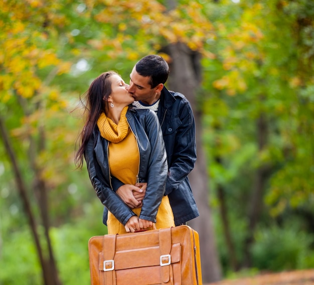 Young couple in love kissing at autumn season outdoor