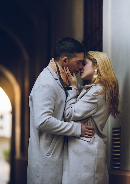 Young couple in love kissing on the street (vertical image)