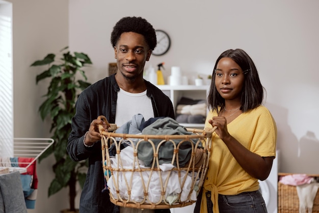 A young couple in love live in a shared apartment perform
household chores keep a wicker basket