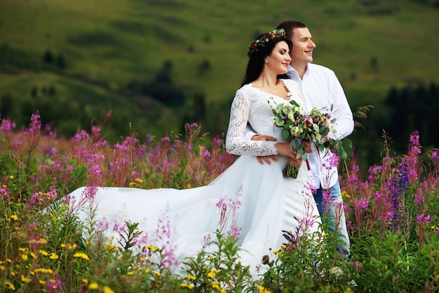 A young couple in love in the mountains on a sunny day. 