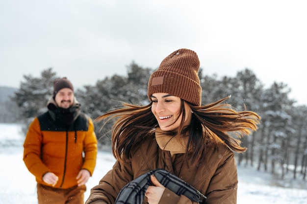 Young couple in love outdoor in snowy winter forest