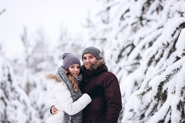 Young couple in love outdoor snowy winter