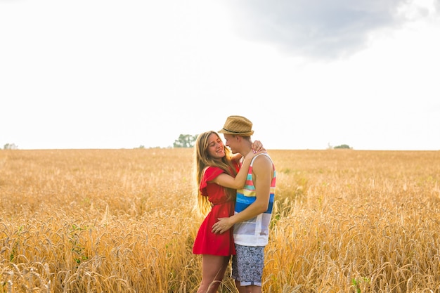 Young couple in love outdoor.Stunning sensual outdoor portrait of young stylish fashion couple posing in summer in field