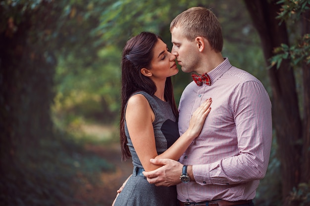 Young couple in love posing in nature