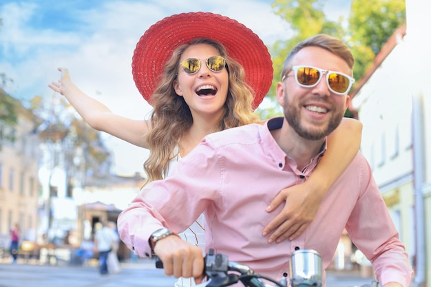 Young couple in love riding a motorbike riders enjoying
themselves on trip adventure and vacations concept